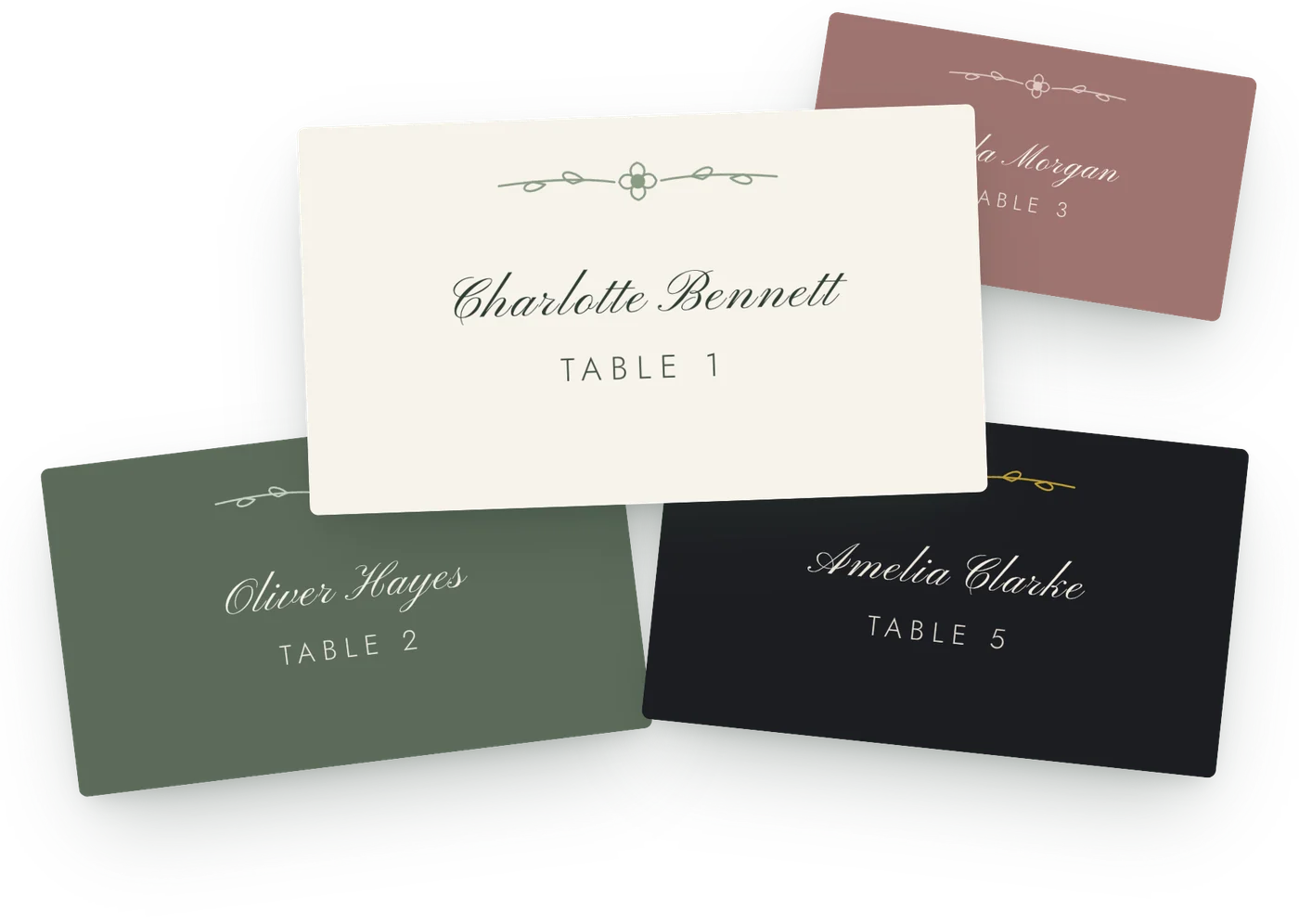Wedding place cards in ivory, sage green, black and dusty rose, each with a guest name in script and a table number